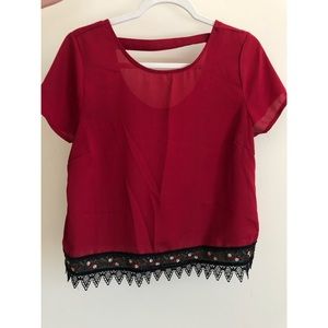 Burgundy sheer top with stitching detail.